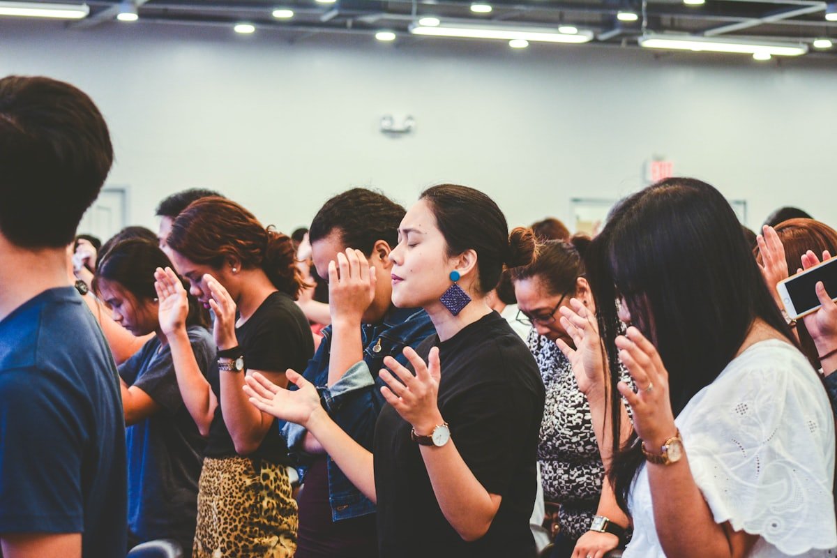 Filipino congregation praying together during a worship service