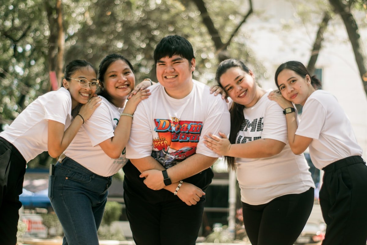 Group of young Filipino volunteers smiling together outdoors