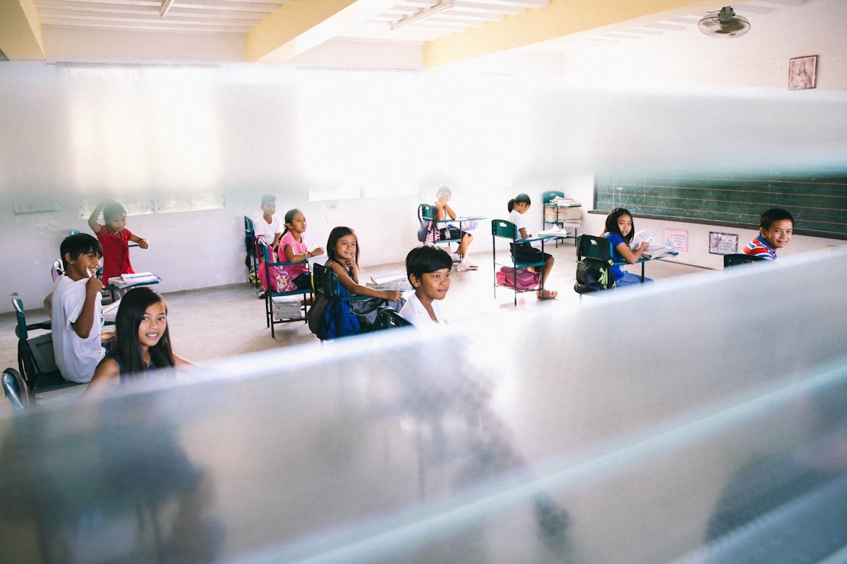 Filipino students seated at desks inside a classroom