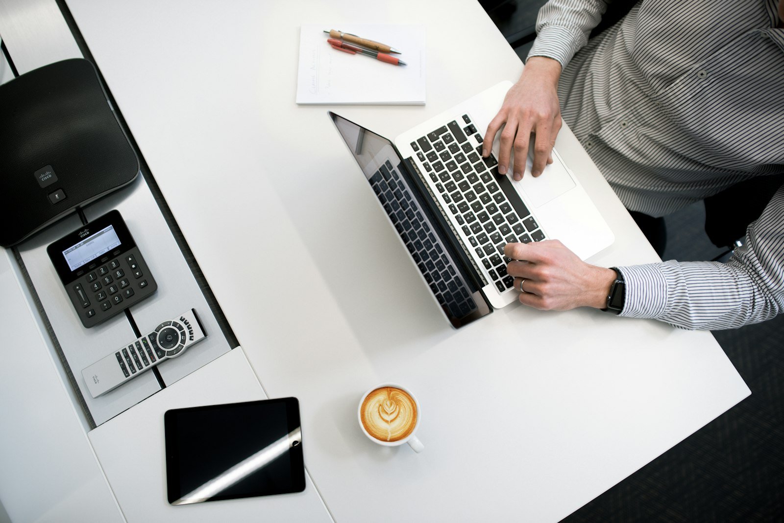Close-up of hands typing on a laptop at a wooden desk, drafting a business email — the kind of everyday quotation or invoice many small business owners in the Philippines still send from a personal Gmail account